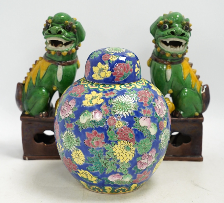 A pair of Chinese lion dogs and a floral enamelled jar and cover, largest 26cm high. Condition - good
